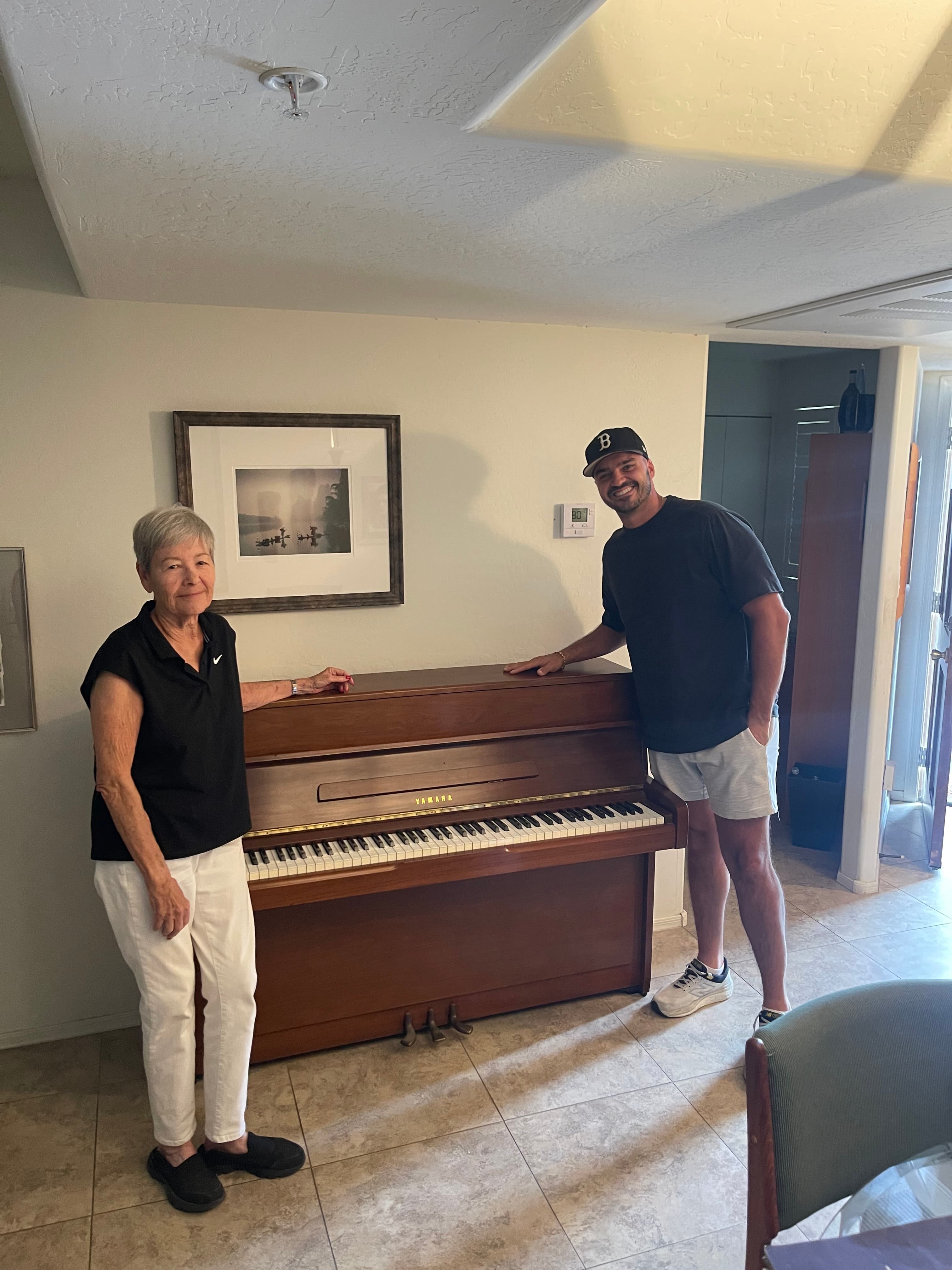 Carmine and Fran R. with the first piano donated to 88 Again
